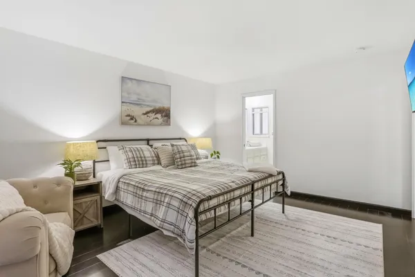 a bedroom with a bed and a table