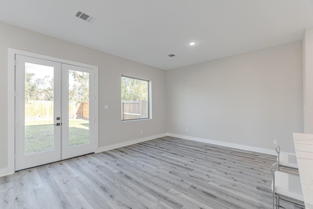 15038 Wunderlust Houston, TX 77069 - Photo 4 of 27 a view of an empty room with wooden floor and a window