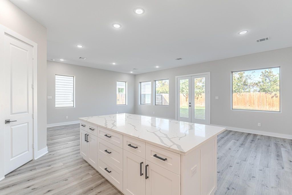 15038 Wunderlust Houston, TX 77069 - Photo 7 of 27 a large white kitchen with granite countertop a large window