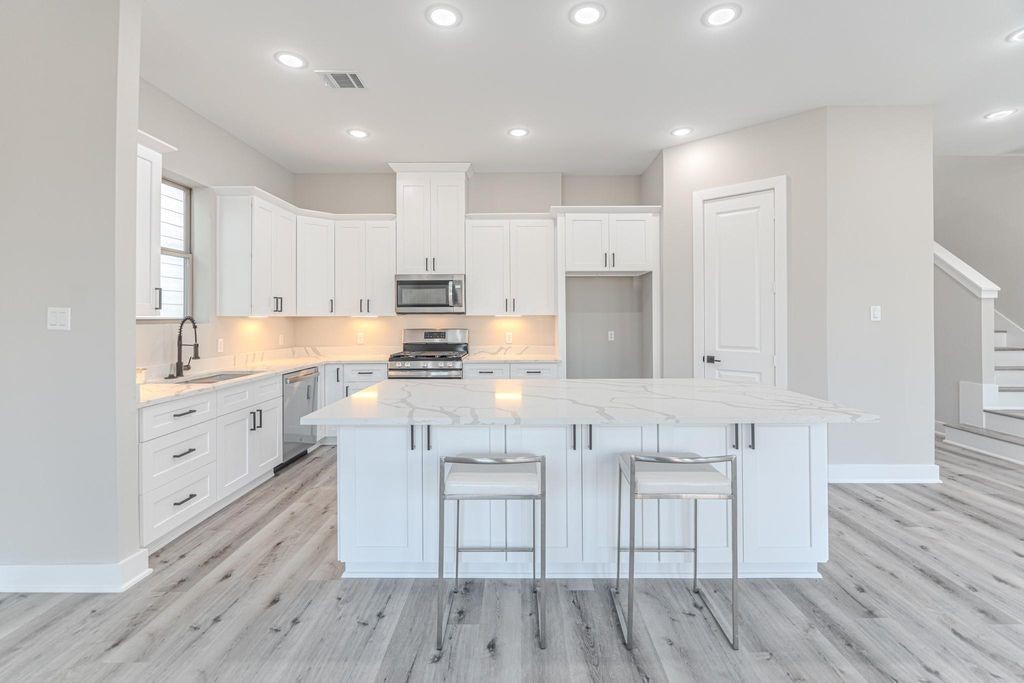 15038 Wunderlust Houston, TX 77069 - Photo 8 of 27 a kitchen with white cabinets and appliances