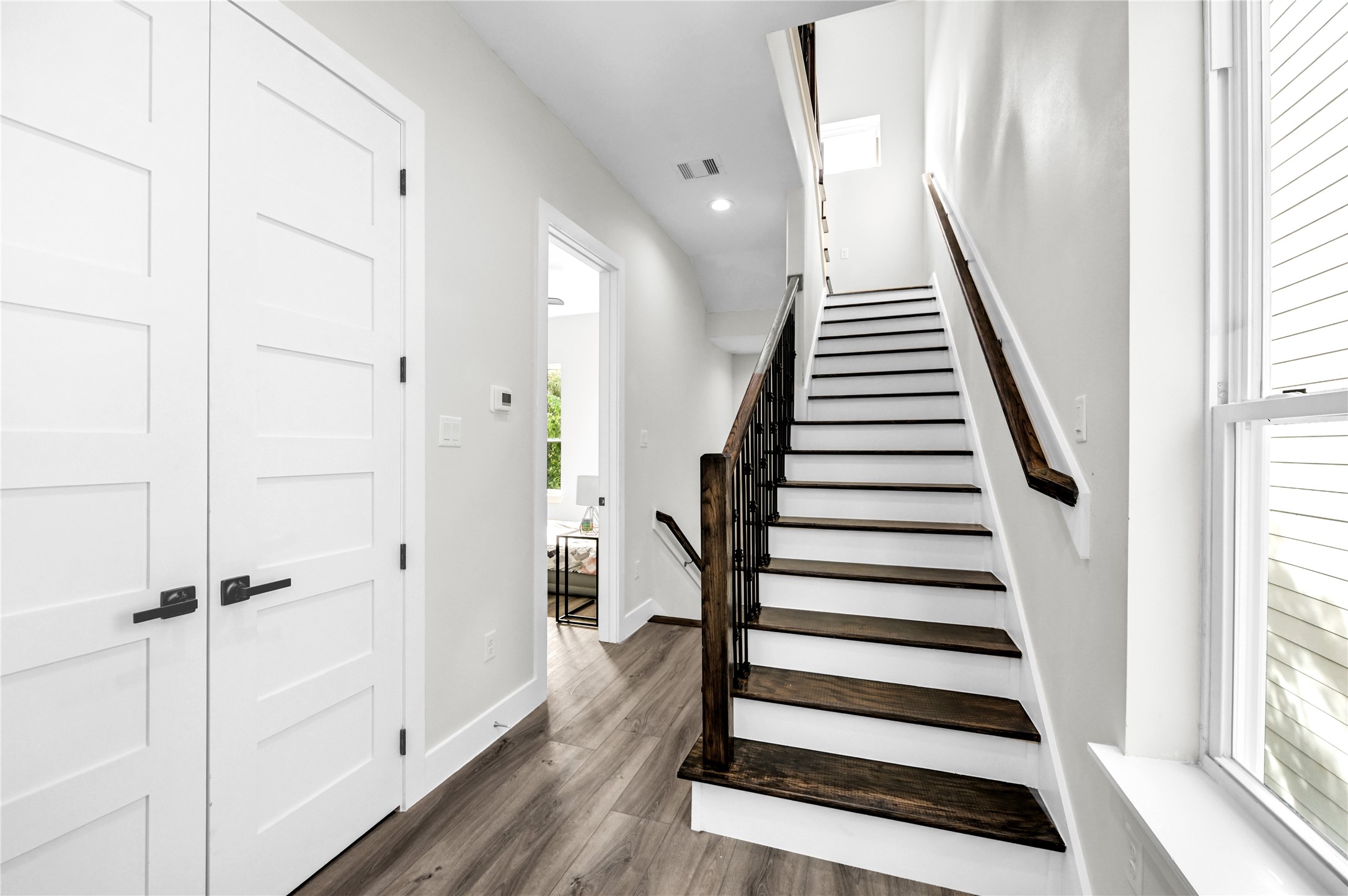 710 Link Road, Unit B Houston, TX 77009 - Photo 18 of 31 a view of entryway with wooden floor and stairs