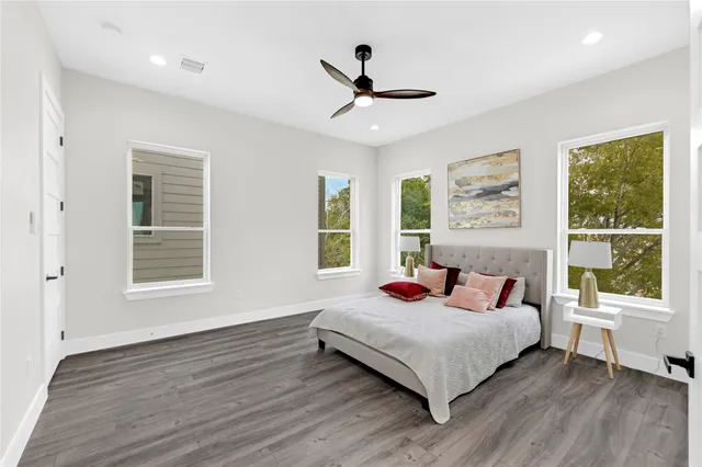 a bedroom with a bed and a large window