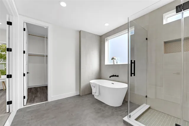 a spacious bathroom with a bathtub and shower