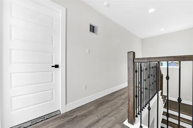 a view of a hallway with wooden floor