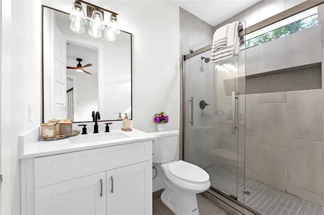 a bathroom with a sink toilet and shower