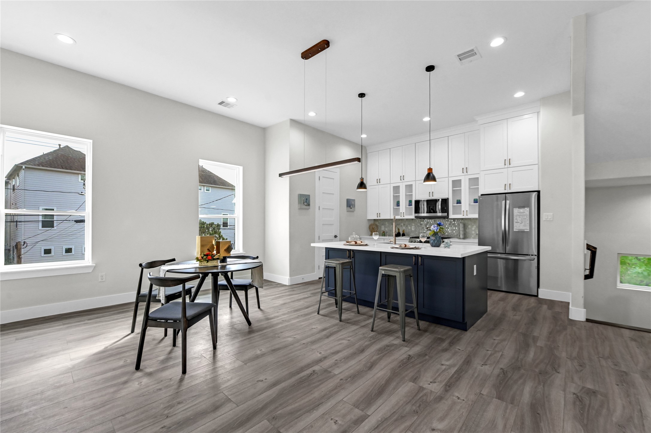 710 Link Road, Unit B Houston, TX 77009 - Photo 9 of 31 a living room with stainless steel appliances kitchen island granite countertop wooden floor a dining table and chairs