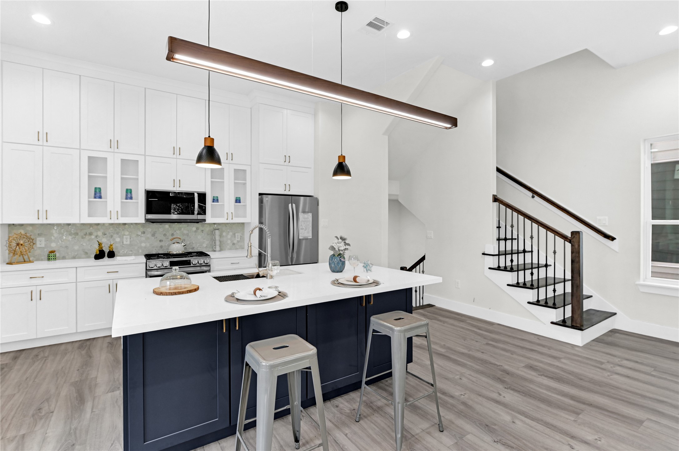 710 Link Road, Unit B Houston, TX 77009 - Photo 10 of 31 a open kitchen with stainless steel appliances kitchen island granite countertop a sink cabinets and wooden floor