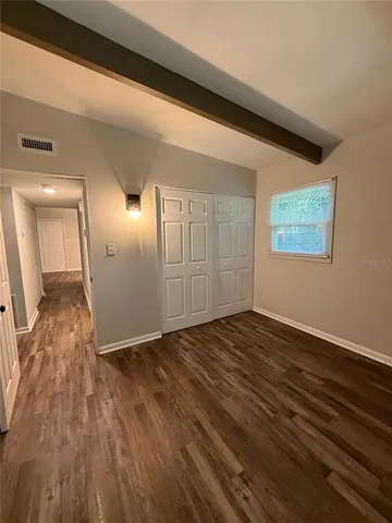 a view of an empty room and wooden floor