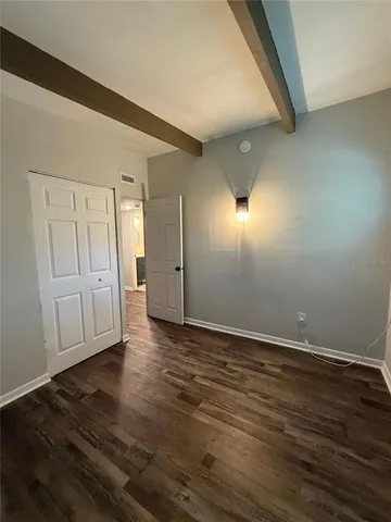 a view of an empty room and wooden floor