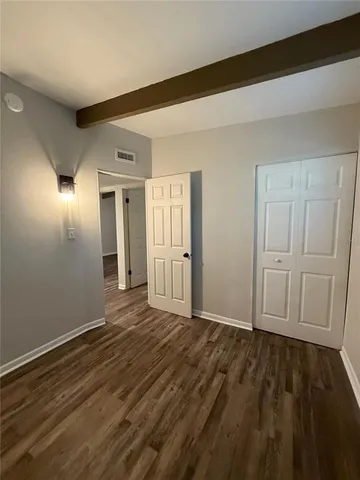 a view of an empty room and wooden floor