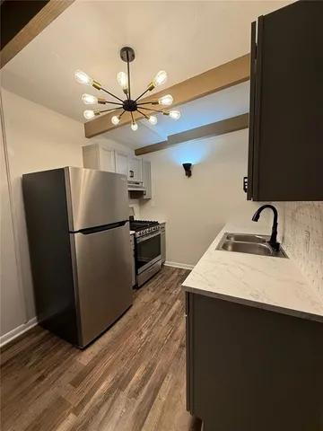 a kitchen with kitchen island a counter top space wooden floor and ceiling fan