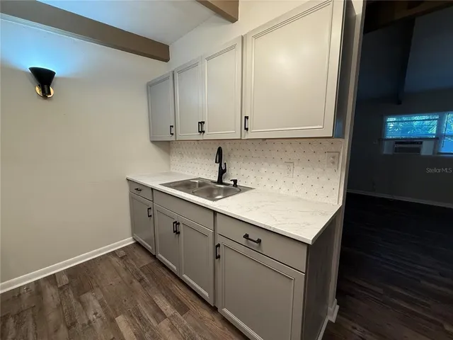 a kitchen with a sink cabinets and a window