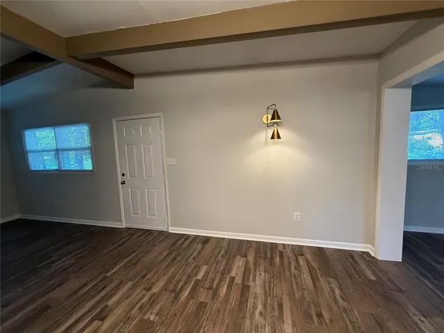 a view of room with wooden floor and ceiling fan