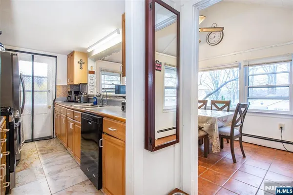 a kitchen with stainless steel appliances granite countertop a refrigerator a sink a stove and island