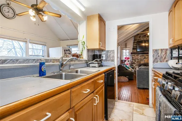 a kitchen with a sink appliances and a counter top space