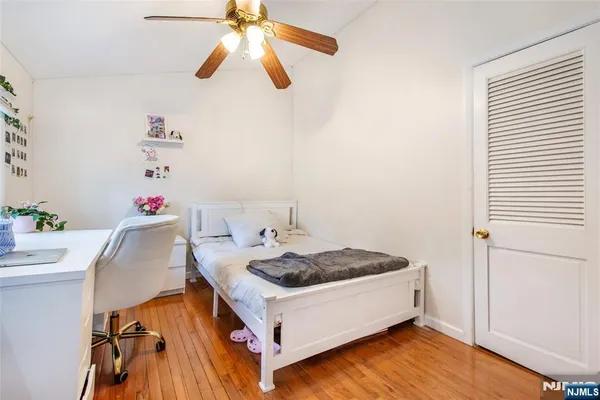 a spacious bedroom with a bed and a chandelier