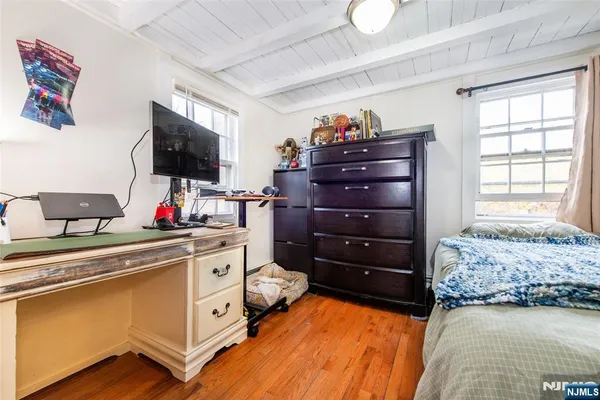 a kitchen with a stove and a flat screen tv