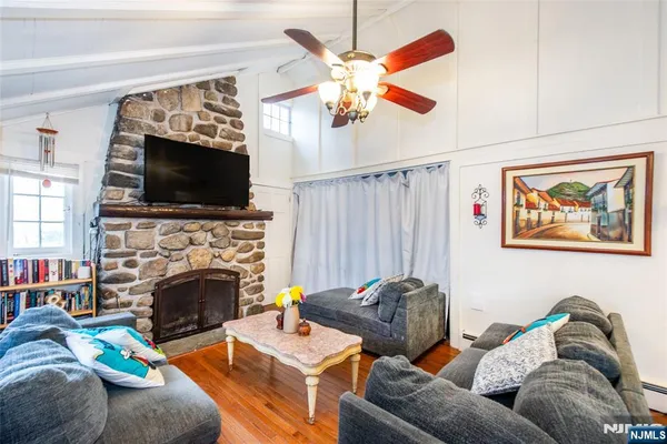 a living room with furniture a flat screen tv and a fireplace