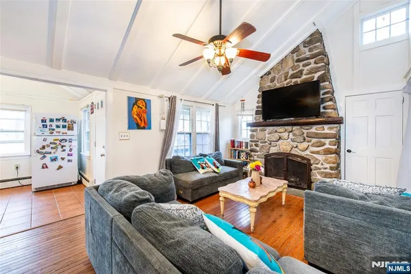 a living room with furniture a flat screen tv and a fireplace