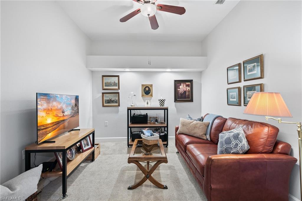 2870 Cypress Trace Circle, Unit 1723 Naples, FL 34119 - Photo 11 of 33 a living room with furniture and a flat screen tv