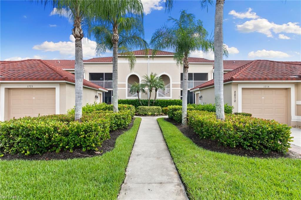 2870 Cypress Trace Circle, Unit 1723 Naples, FL 34119 - Photo 21 of 33 a view of a back yard of the house