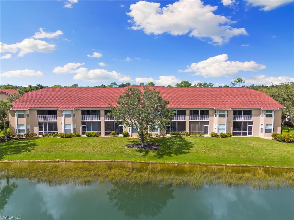 2870 Cypress Trace Circle, Unit 1723 Naples, FL 34119 - Photo 26 of 33 a front view of a house with swimming pool having outdoor seating