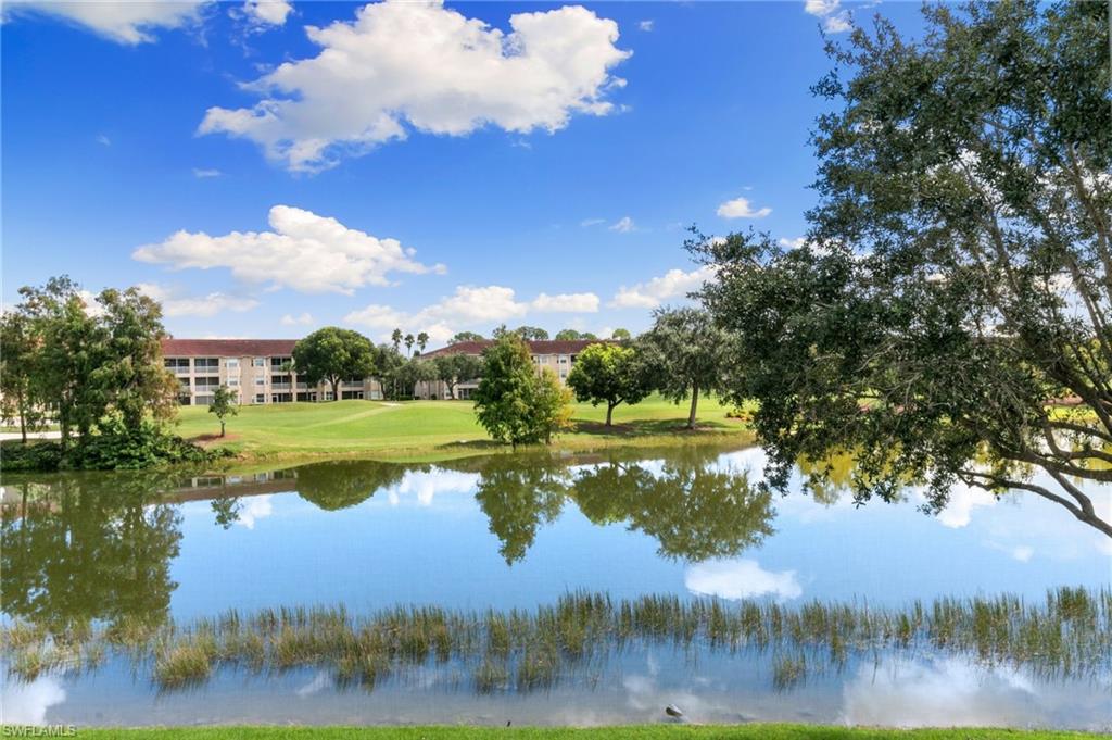 2870 Cypress Trace Circle, Unit 1723 Naples, FL 34119 - Photo 30 of 33 a view of lake with green space