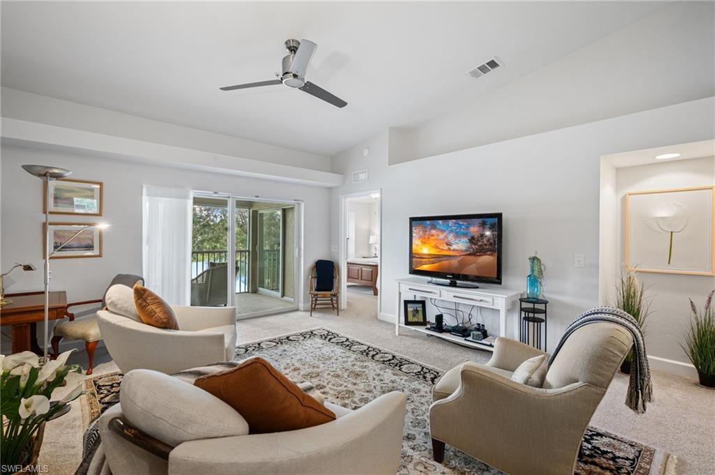 2870 Cypress Trace Circle, Unit 1723 Naples, FL 34119 - Photo 4 of 33 a living room with furniture and a flat screen tv