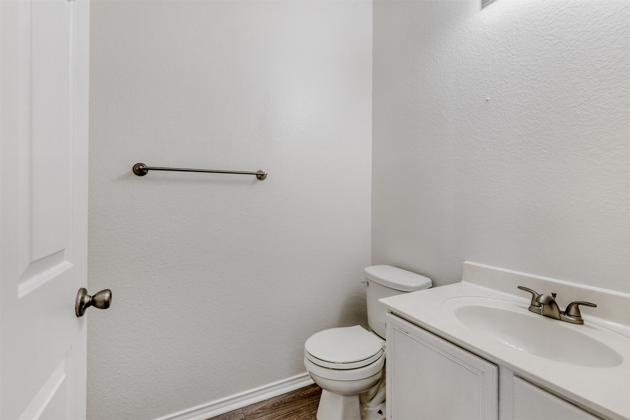 4508 Peach Grove Road Austin, TX 78744 - Photo 11 of 24 Half bath featuring vanity, a textured wall, and dark wood finished floors