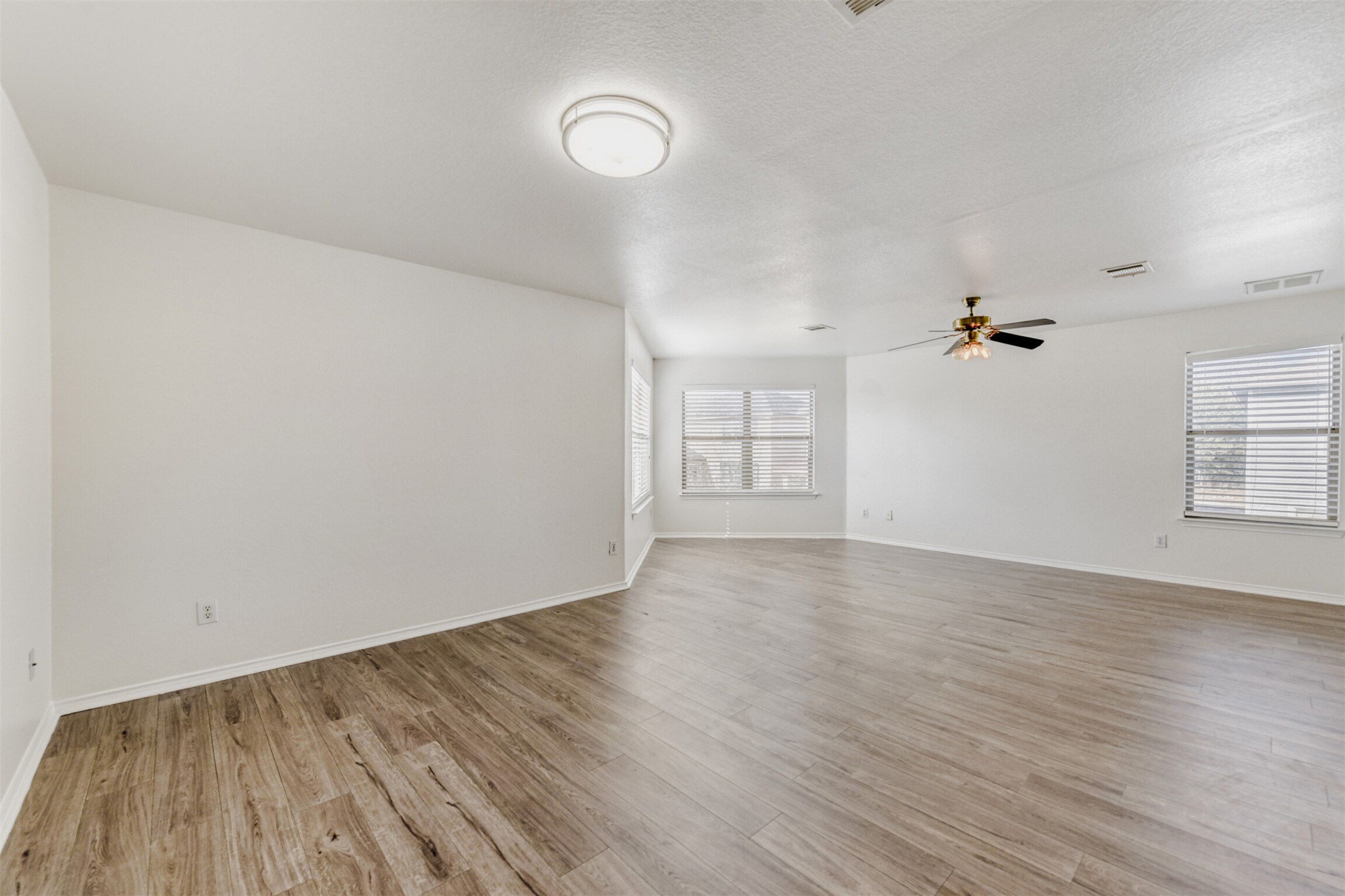 4508 Peach Grove Road Austin, TX 78744 - Photo 14 of 24 Empty room with light wood-style flooring and a ceiling fan