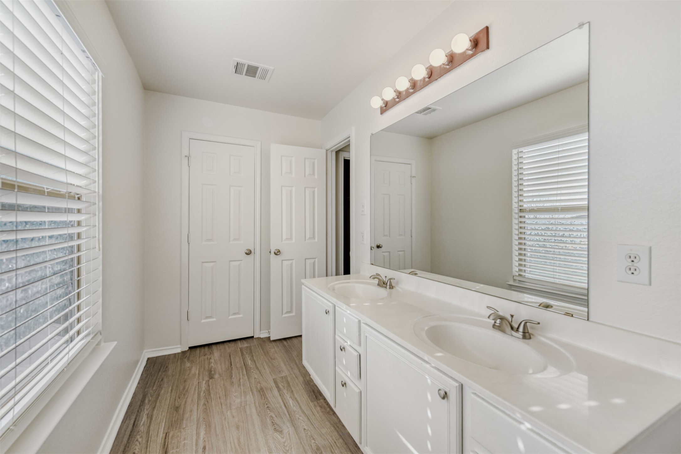 4508 Peach Grove Road Austin, TX 78744 - Photo 16 of 24 Full bath with double vanity and light wood-type flooring