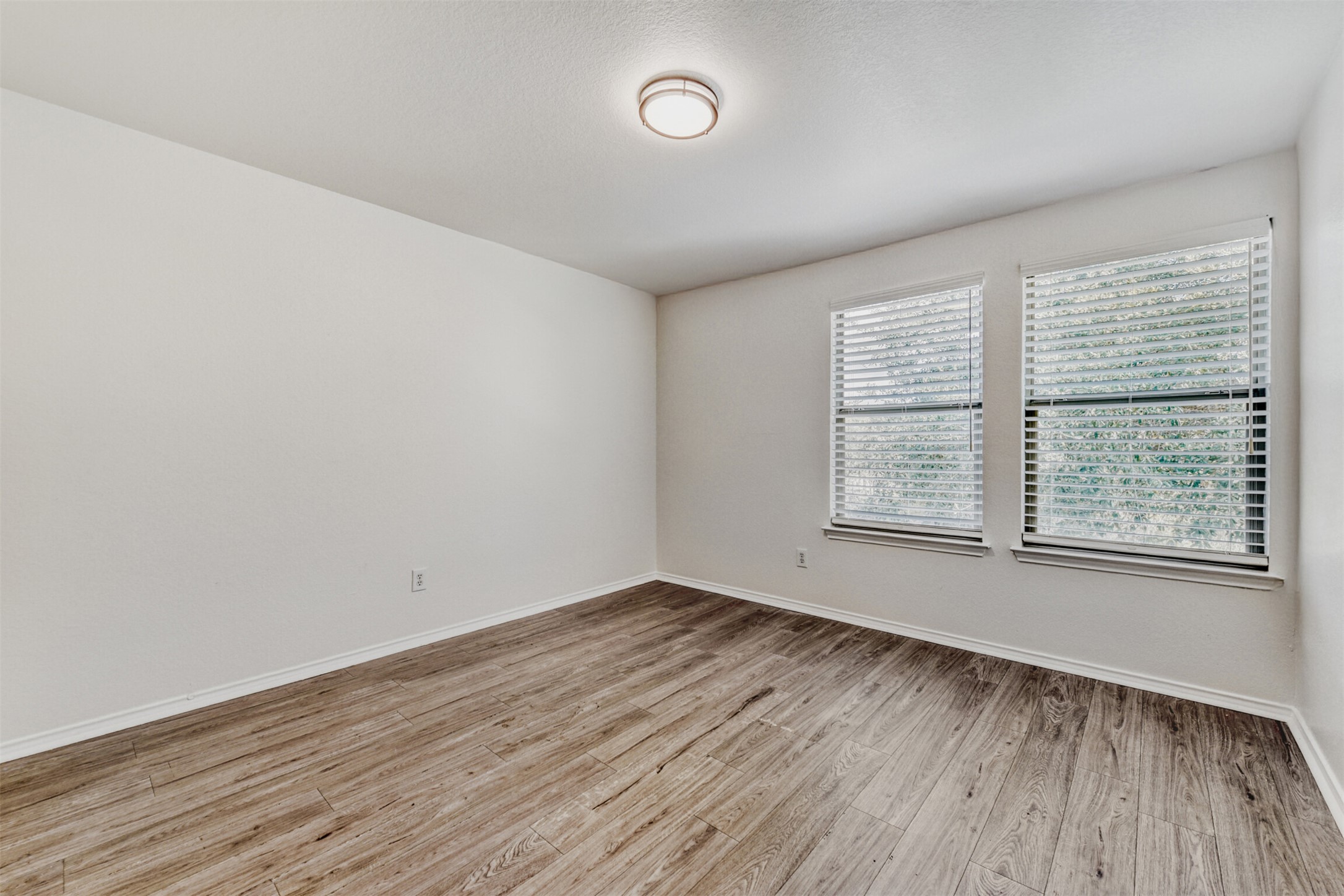 4508 Peach Grove Road Austin, TX 78744 - Photo 18 of 24 Unfurnished room featuring light wood-type flooring and baseboards