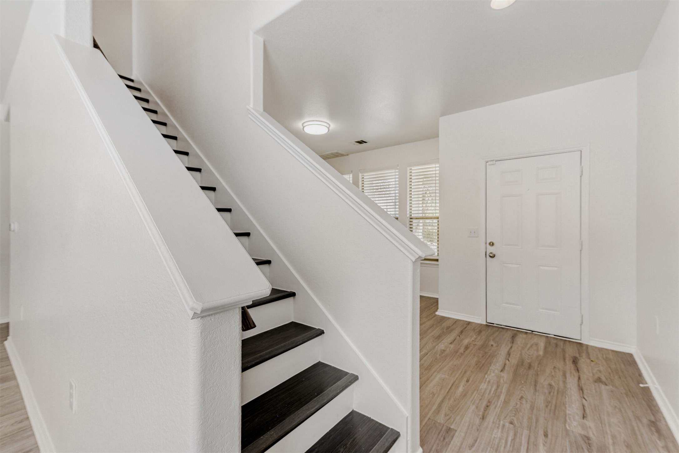 4508 Peach Grove Road Austin, TX 78744 - Photo 3 of 24 Stairway with wood finished floors