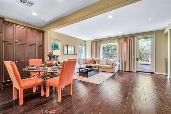 a kitchen with stainless steel appliances a dining table and chairs