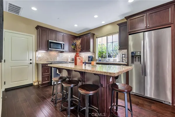 a kitchen with granite countertop a sink and a window