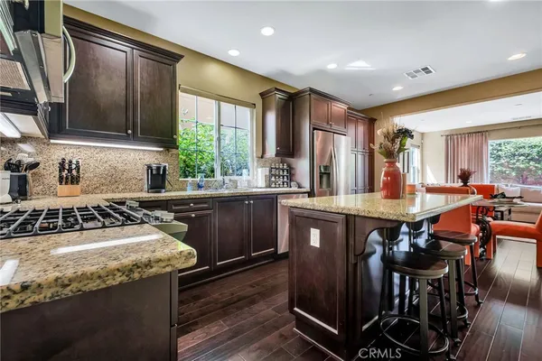 a kitchen with stainless steel appliances granite countertop a stove and a microwave
