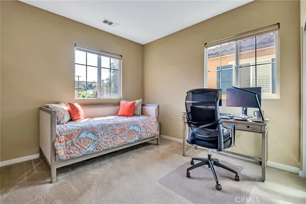 a view of a livingroom with workspace and a couch