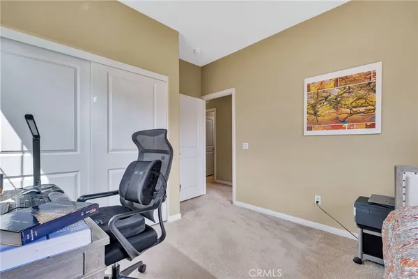 a view of a workspace with furniture and a window