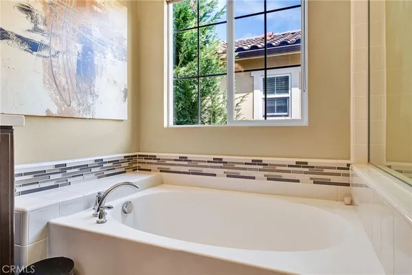 a view of a house with backyard and potted plants