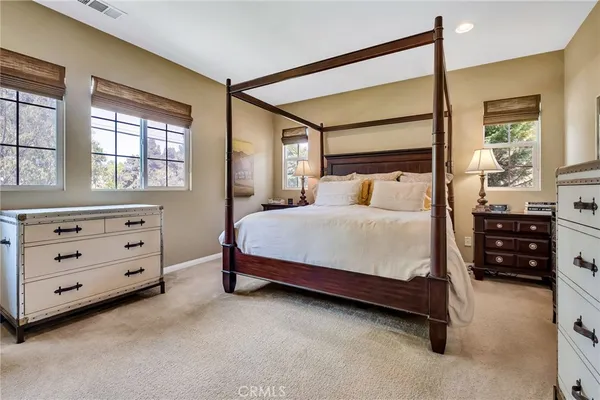 a living room with furniture large window and wooden floor