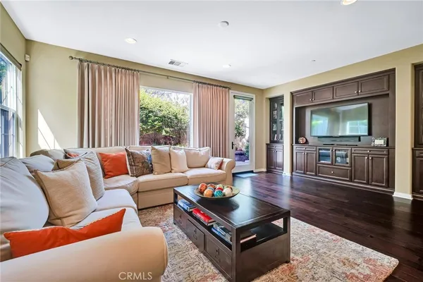 a living room with furniture and wooden floor