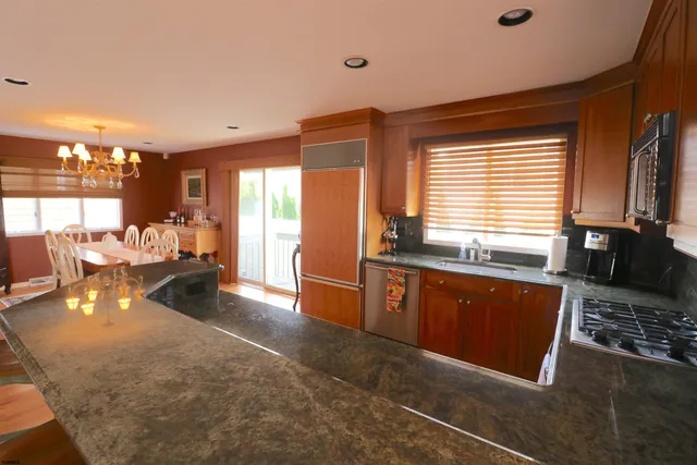 a kitchen with granite countertop a stove and a sink