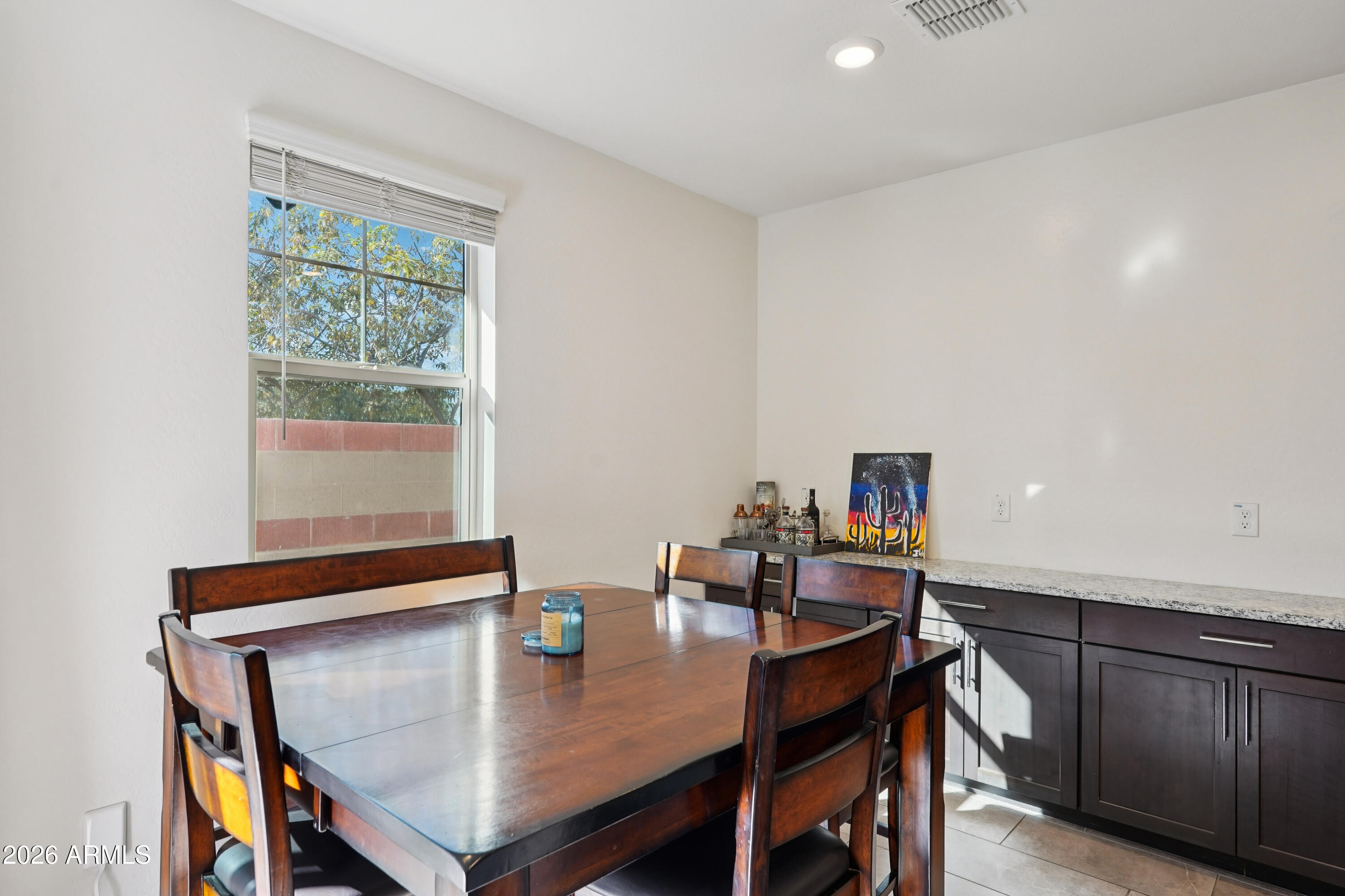 17153 North 10th Street Phoenix, AZ 85022 - Photo 14 of 48 a view of a dining room with furniture and a window