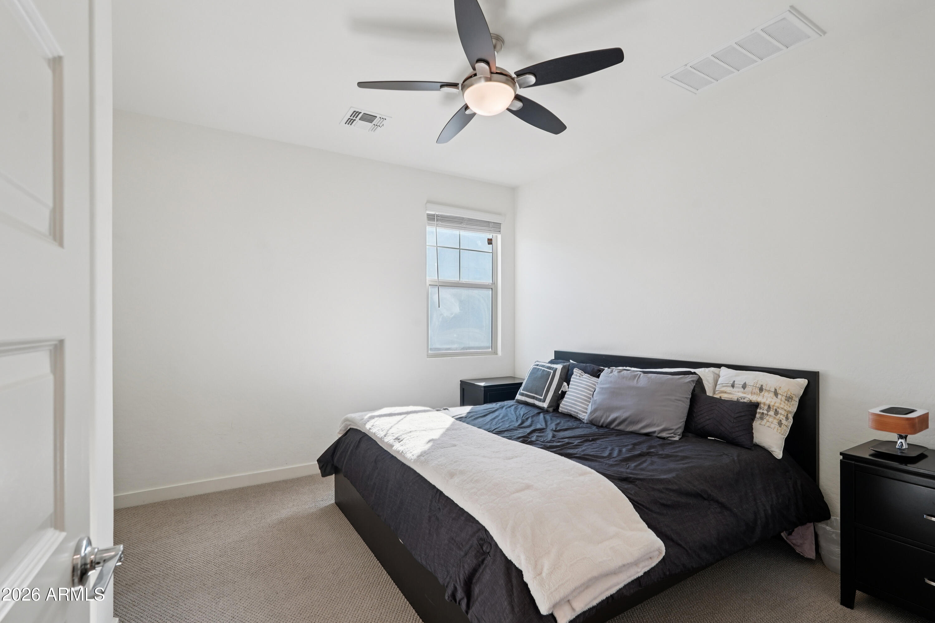 17153 North 10th Street Phoenix, AZ 85022 - Photo 33 of 48 a bedroom with a bed and window
