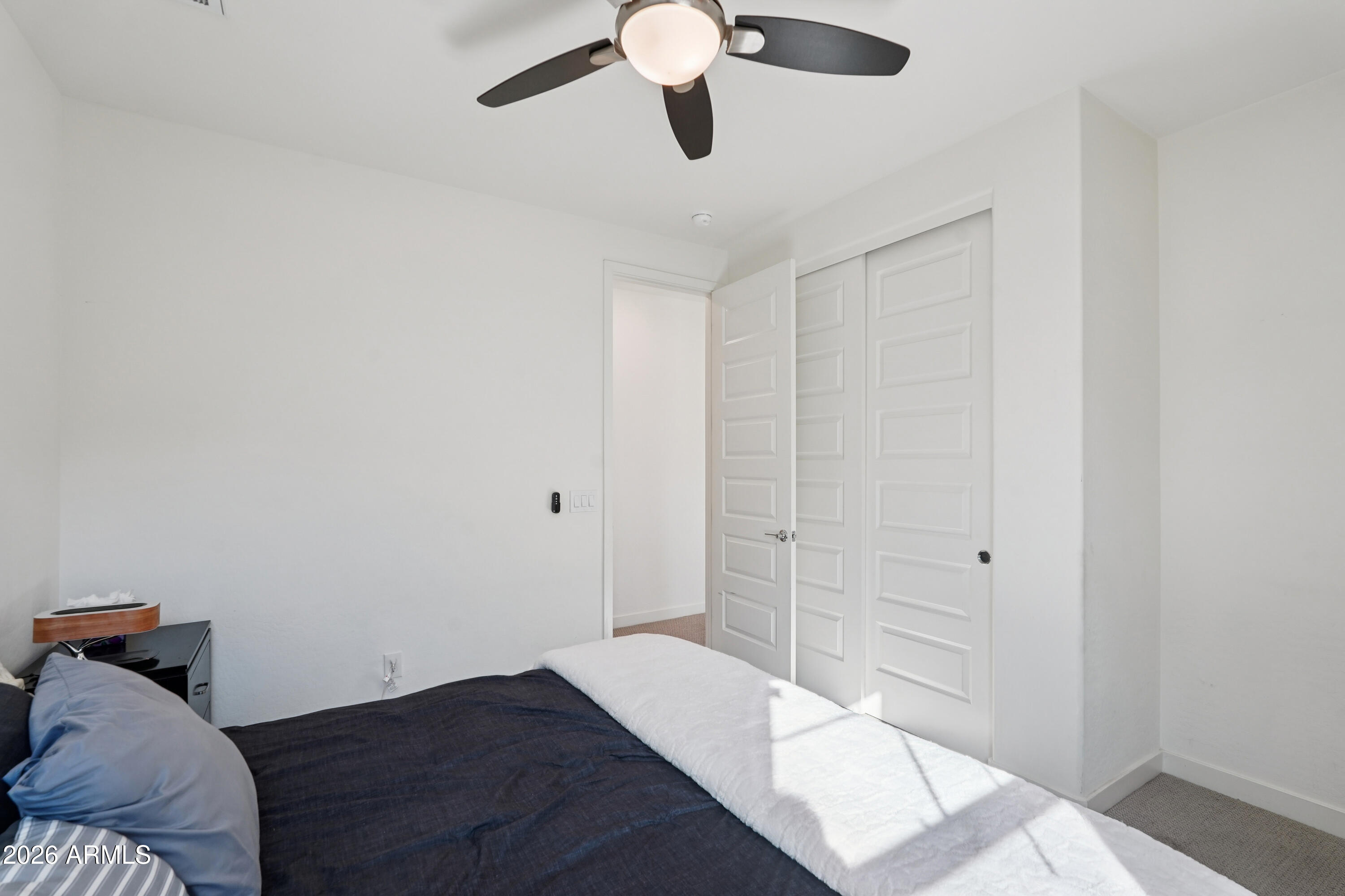 17153 North 10th Street Phoenix, AZ 85022 - Photo 34 of 48 a bedroom with a bed and a chandelier