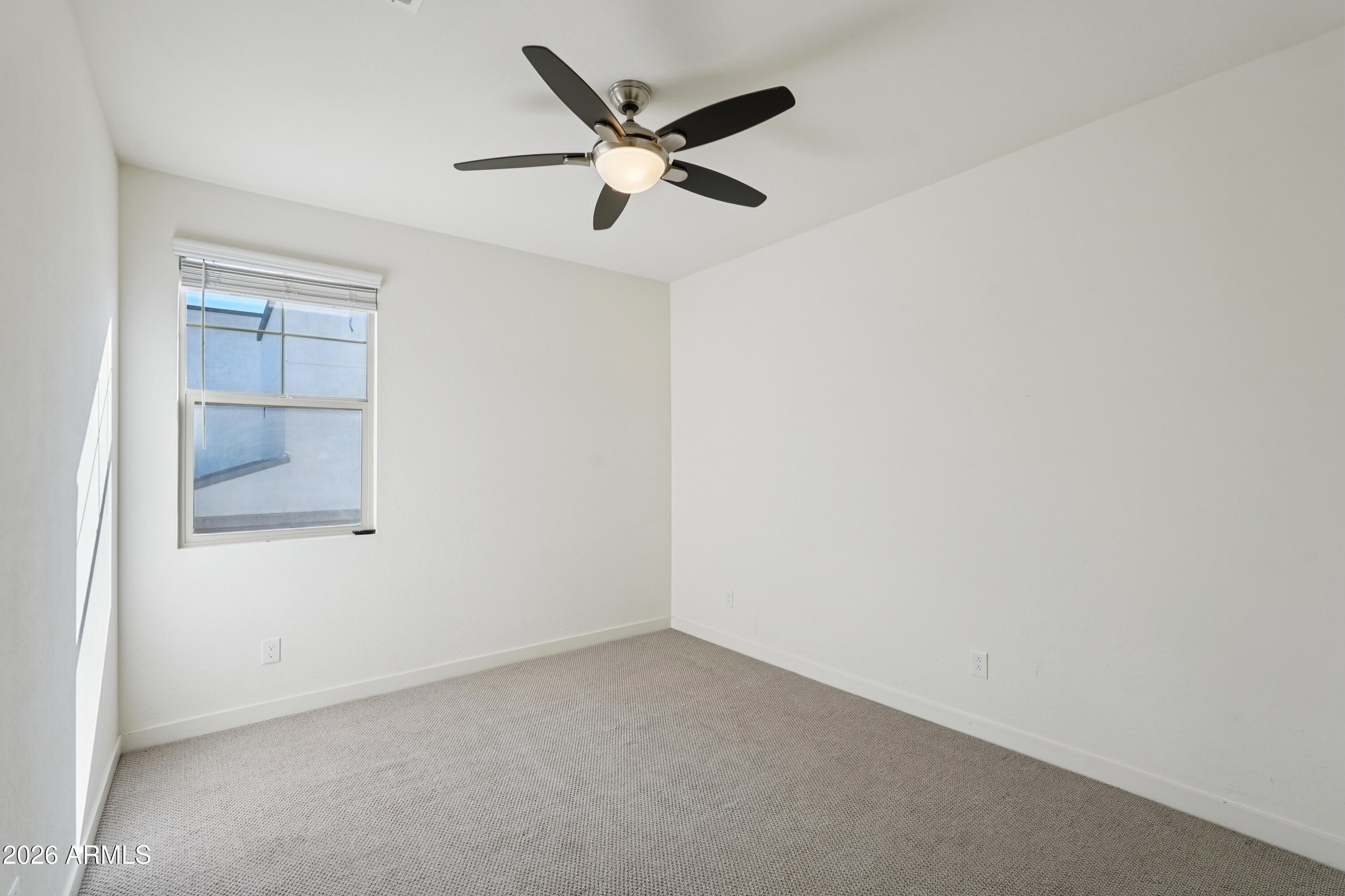 17153 North 10th Street Phoenix, AZ 85022 - Photo 35 of 48 an empty room with a ceiling fan and wooden floor
