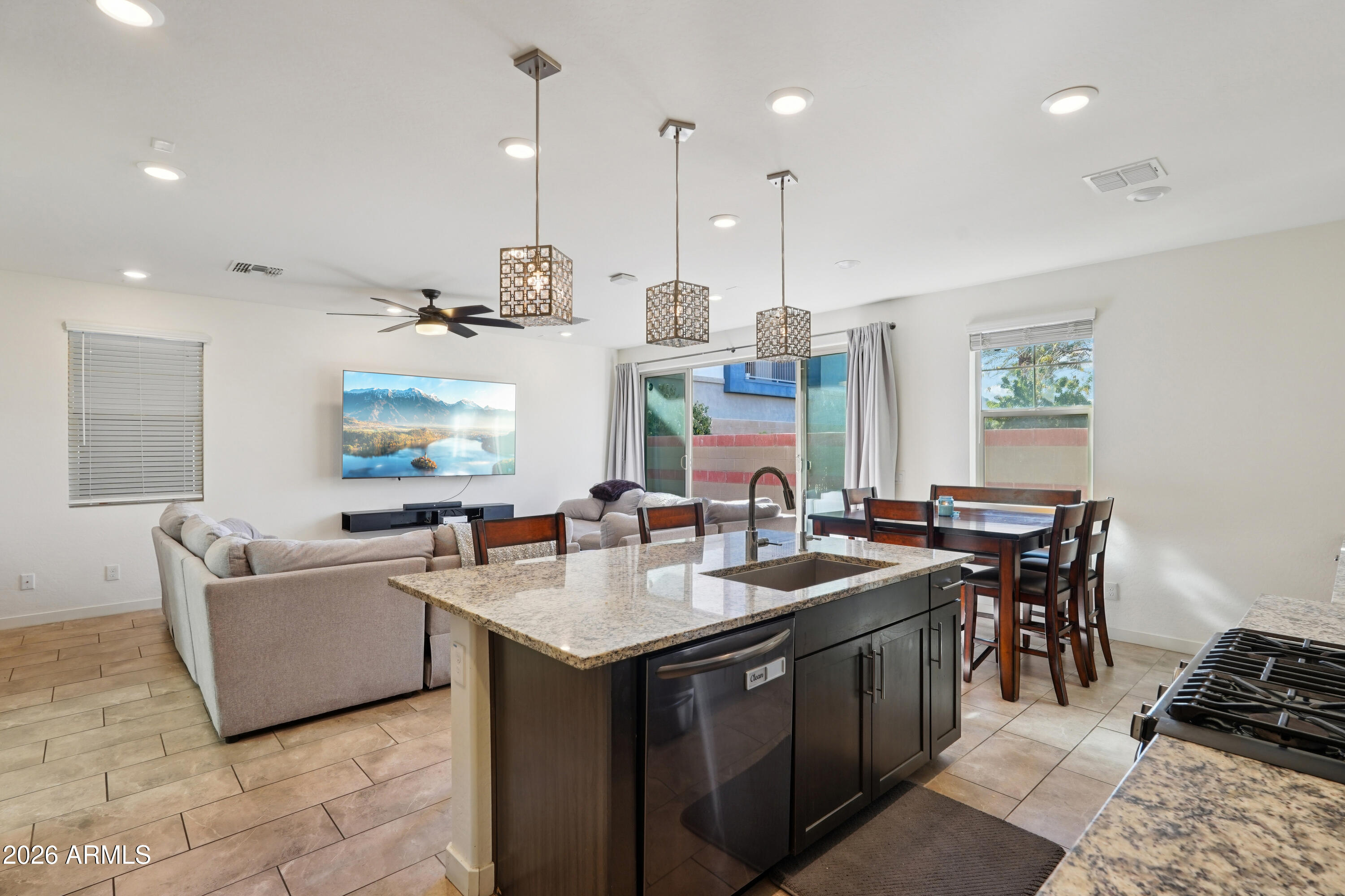 17153 North 10th Street Phoenix, AZ 85022 - Photo 8 of 48 a open kitchen with stainless steel appliances granite countertop a sink a stove and a refrigerator