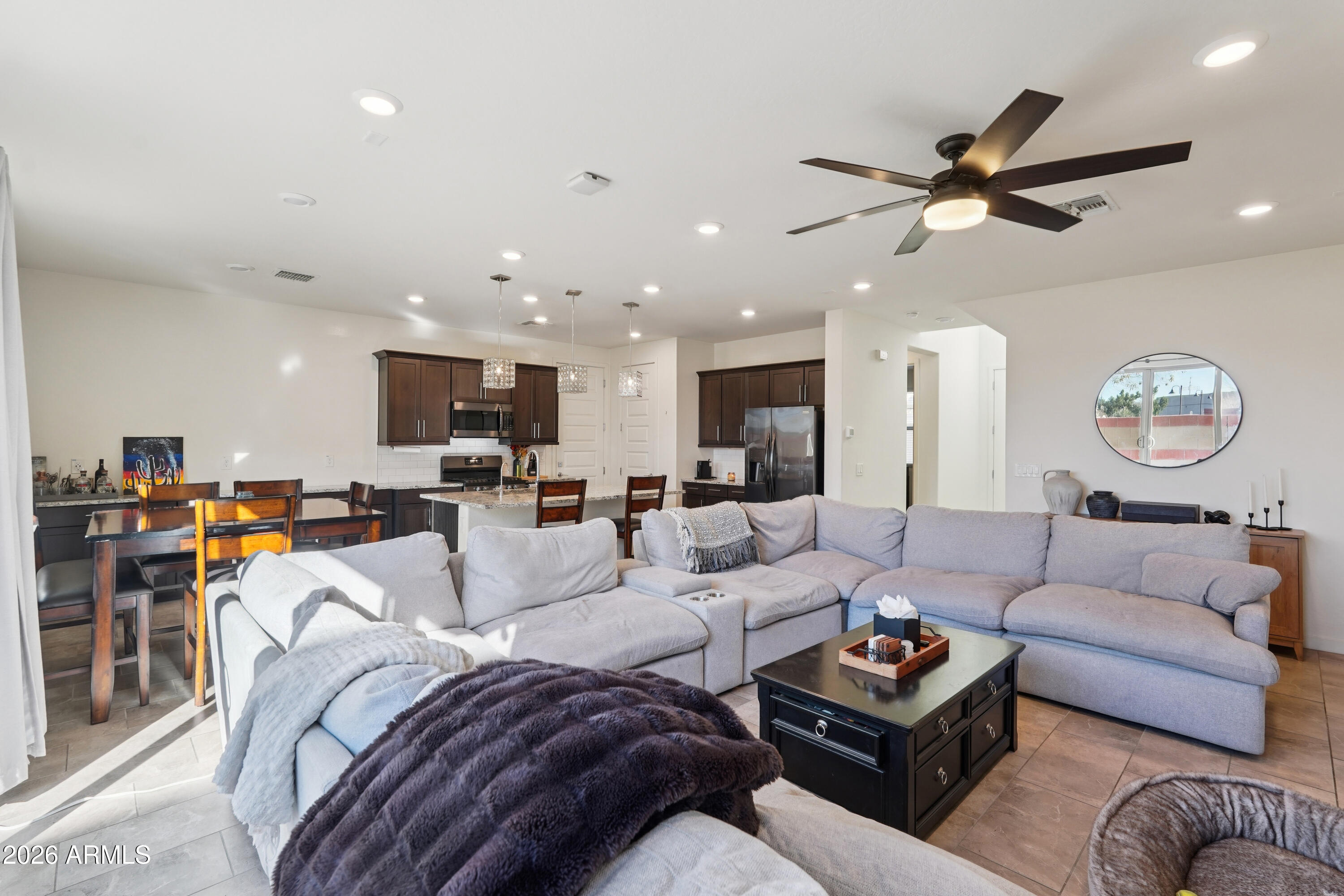 17153 North 10th Street Phoenix, AZ 85022 - Photo 10 of 48 a living room with furniture a clock and a ceiling fan