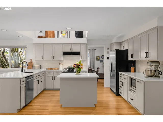 a kitchen with cabinets and wooden floor