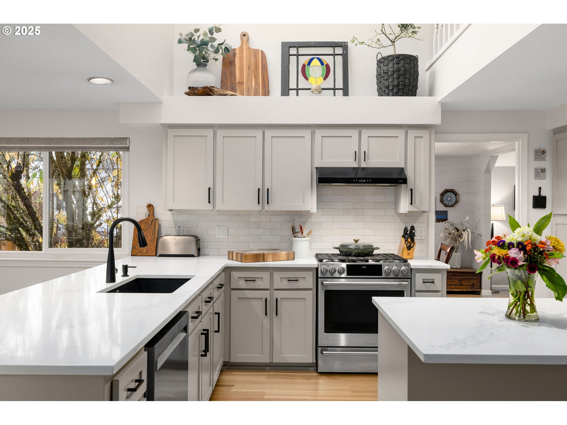 12808 Southwest Falcon Rise Drive Portland, OR 97223 - Photo 17 of 46 a kitchen with a sink a stove and cabinets
